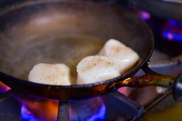 Scallops cooking in pan